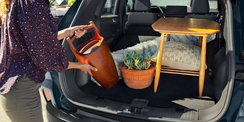 Person loading things into the back of a 2026 Ford Escape